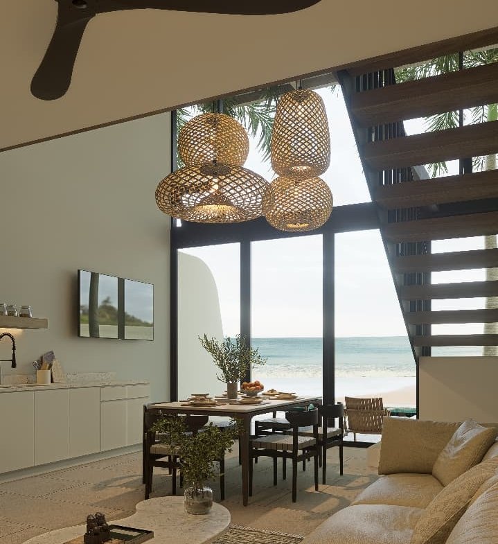 Bright living room with modern furniture and ocean-inspired décor in a Playa Remanso beachfront condo
