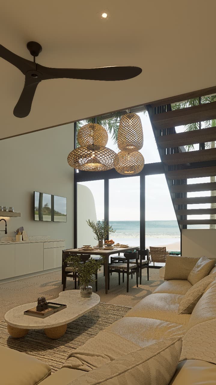 Bright living room with modern furniture and ocean-inspired décor in a Playa Remanso beachfront condo