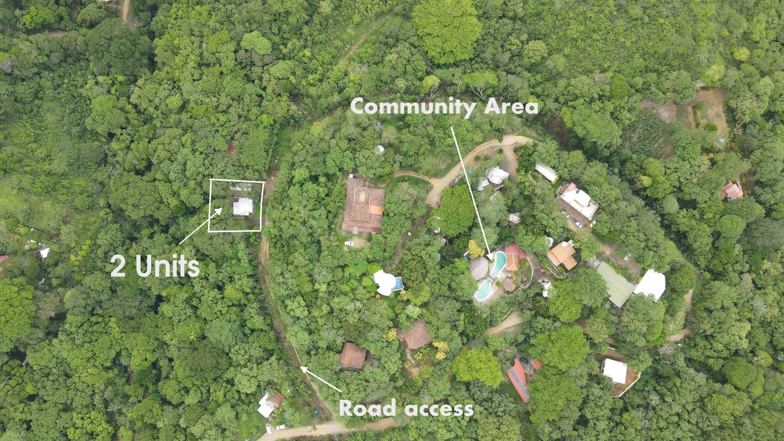 Aerial drone view of property for sale in San Juan del Sur with two homes, green common area and access road in the Camino del Sol gated community
