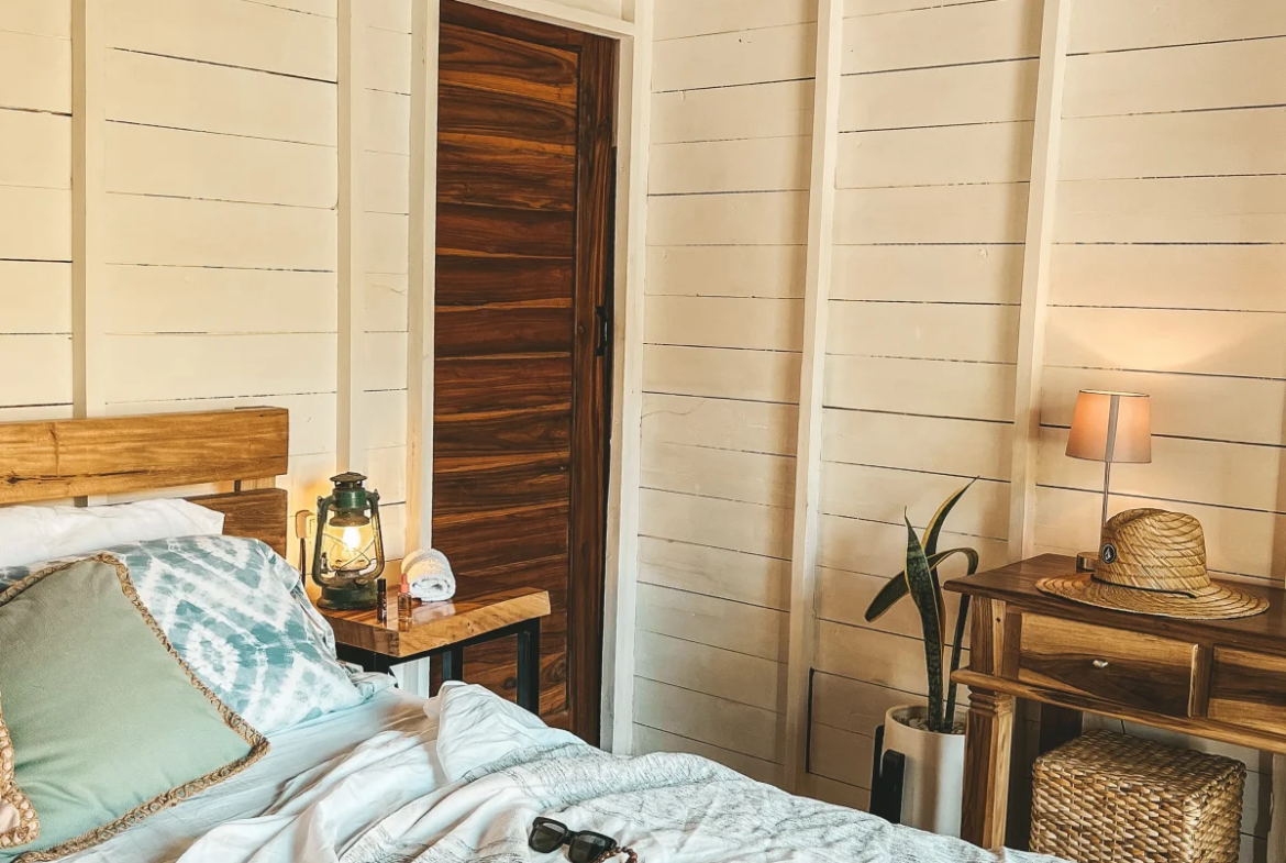 Cozy bungalow bedroom interior at Monoloko Lodge boutique surf retreat near Playa Santana, Tola, Nicaragua