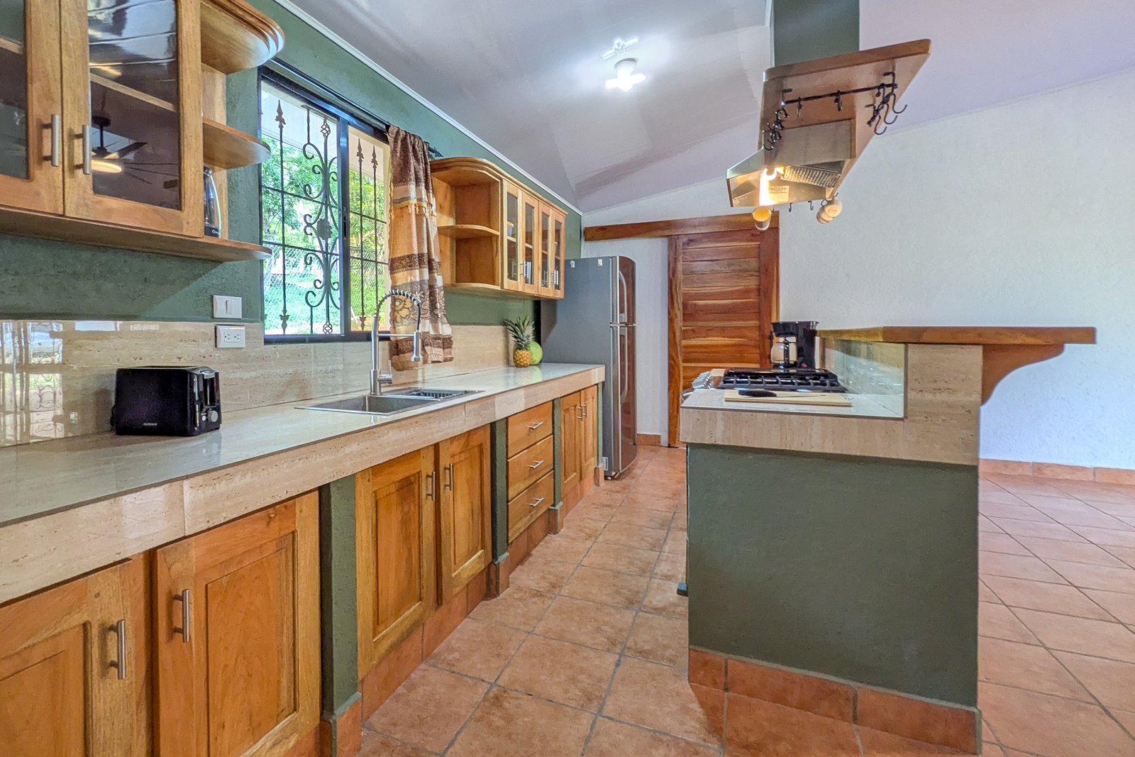 Open concept kitchen with solid wood cabinetry