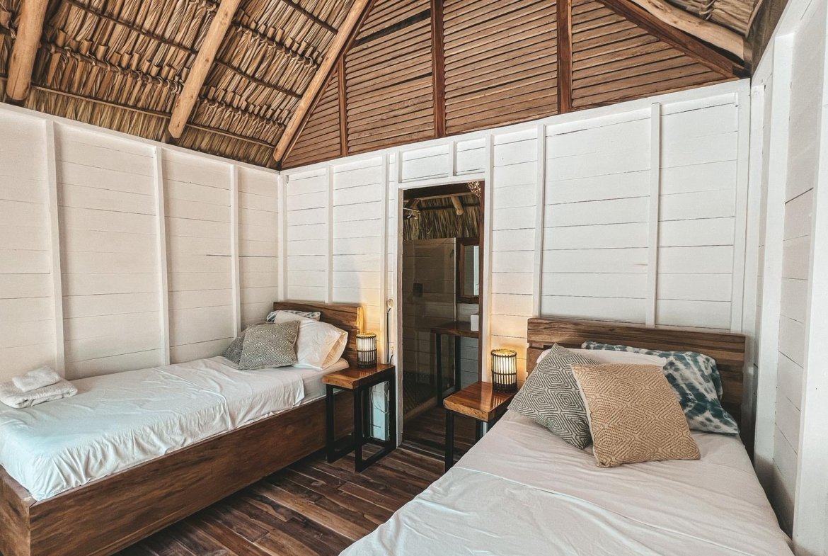 Double bed in a wooden bungalow at Monoloko Lodge, a surf lodge for sale near Playa Santana, Popoyo, Nicaragua