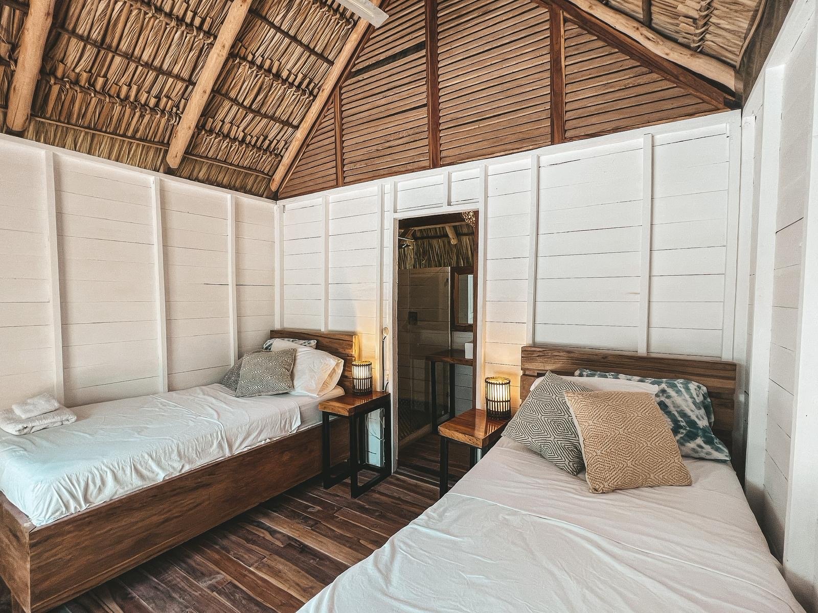 Double bed in a wooden bungalow at Monoloko Lodge, a surf lodge for sale near Playa Santana, Popoyo, Nicaragua
