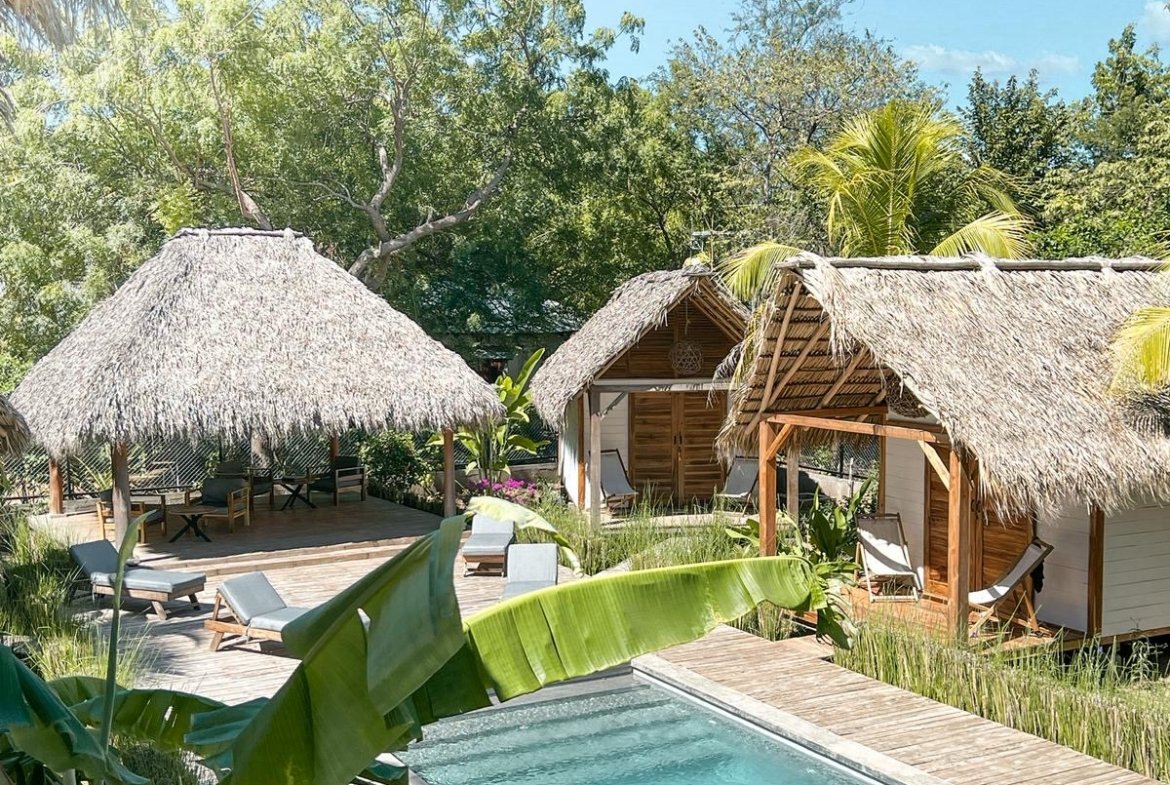 Pool view with wooden bungalows at Monoloko Lodge, Popoyo, Nicaragua