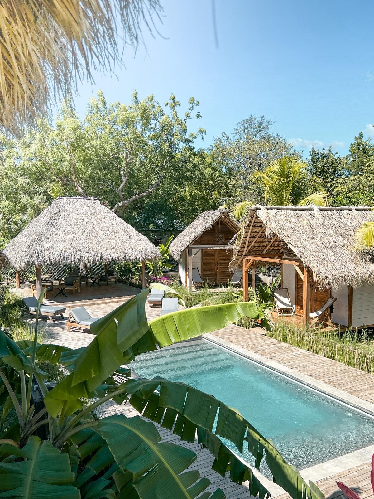 Pool view with wooden bungalows at Monoloko Lodge, Popoyo, Nicaragua