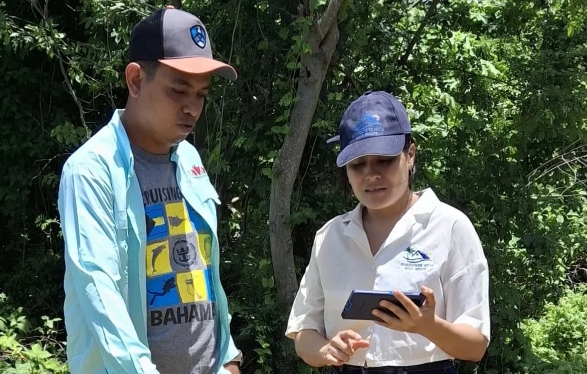 Sayonara Valle Calderón, licensed real estate broker, with a surveyor during a property survey in San Juan del Sur, Nicaragua