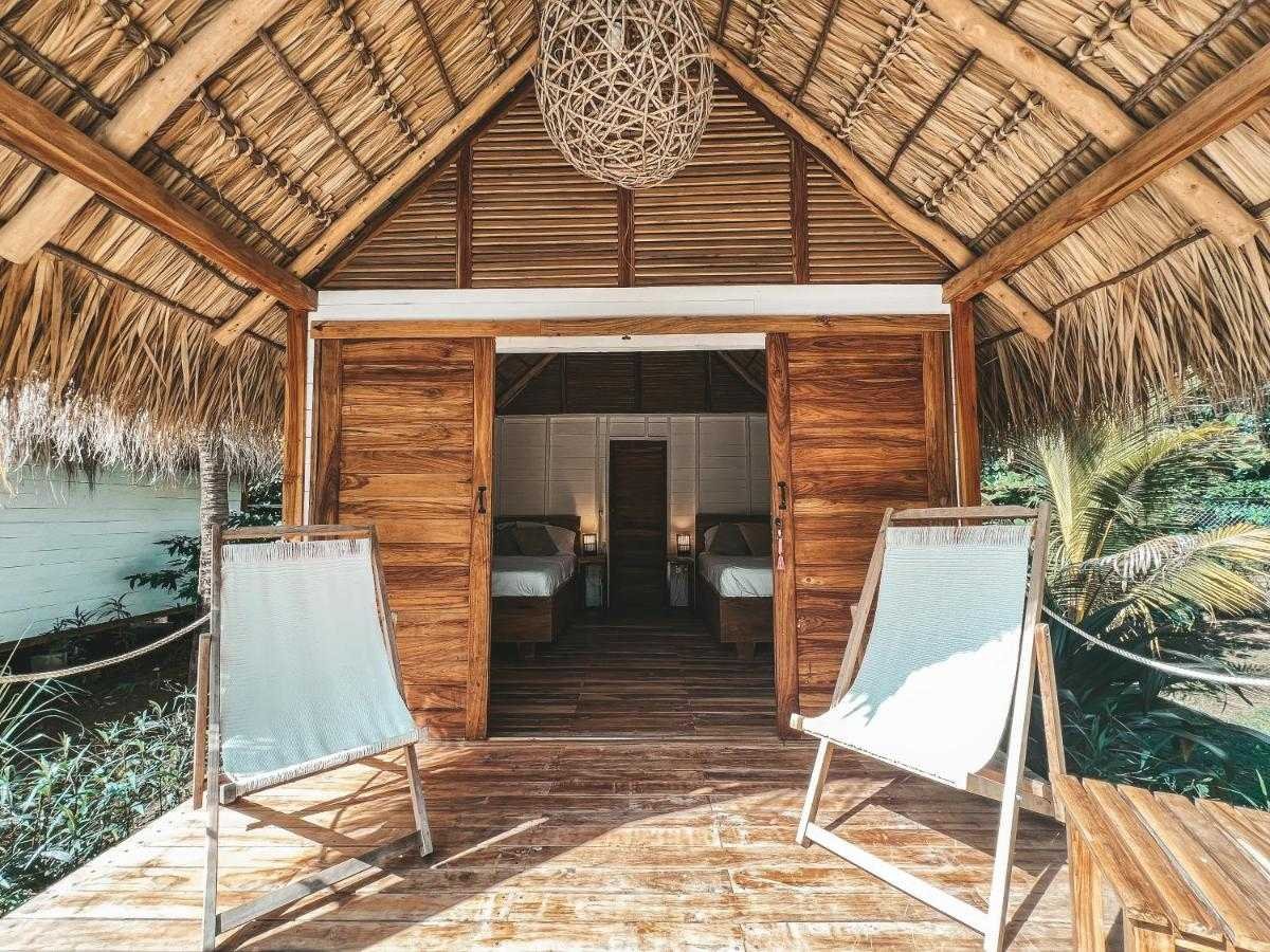 Guest room for two with wooden interiors at Monoloko Lodge surf retreat near Playa Santana, Nicaragua