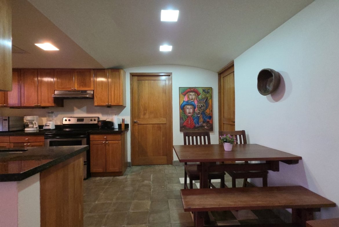 Open kitchen and dining area in a furnished home at Villas de Palermo, Nicaragua