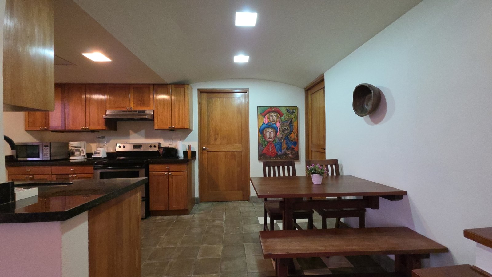 Open kitchen and dining area in a furnished home at Villas de Palermo, Nicaragua