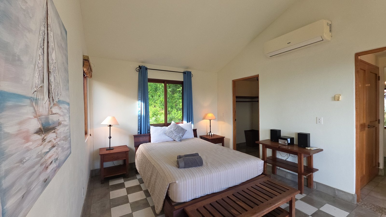 Master bedroom with wooden furniture and ceiling fan at Villas de Palermo, San Juan del Sur