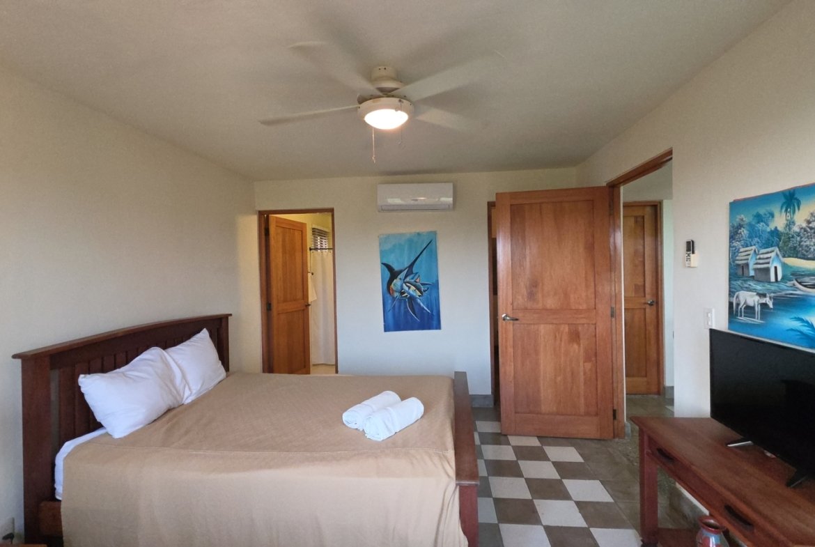 Second bedroom with comfortable bed in a home at Villas de Palermo, San Juan del Sur