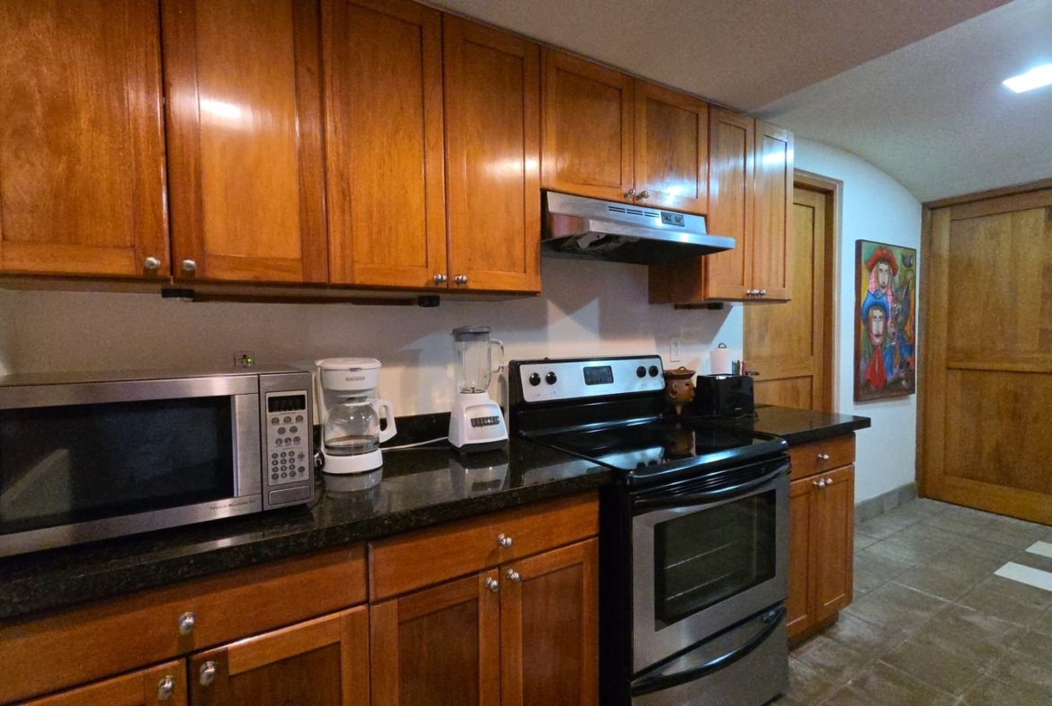 Kitchen stove and cooking area in a furnished home at Villas de Palermo, Nicaragua