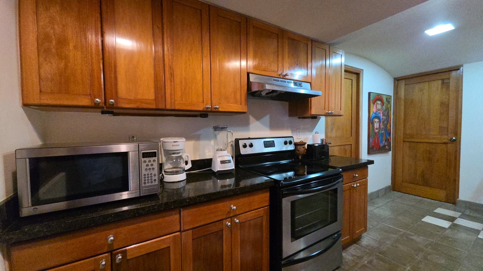 Kitchen stove and cooking area in a furnished home at Villas de Palermo, Nicaragua
